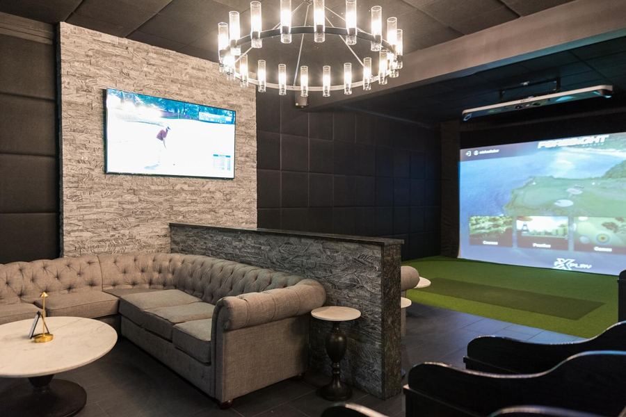A golf simulator bay at Tees & Taps on Hertel Avenue
